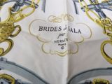a close up of a handkerchief with a gold and blue design on it