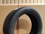tire on the floor of a warehouse with cardboard boxes in the background