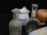 many different types of glass vases on the table