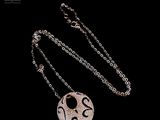 silver plated necklace with a smiley face on a chain on a black background