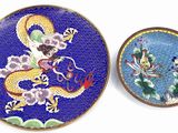 two plates that have dragon designs on them