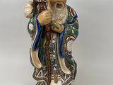 une image représentant une figurine d'un homme tenant un bâton