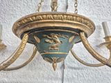 a chandelier hanging from the ceiling with a bird on it