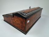 an old wooden box with a black handle on a white background