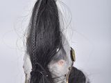 a doll with a long black hair and a helmet on it