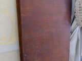 a wooden table with a brown top in a corner of a room