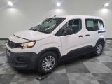 the white van is parked on a checkered floor in the garage