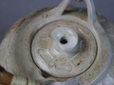 a close up of a tea pot with a wooden handle
