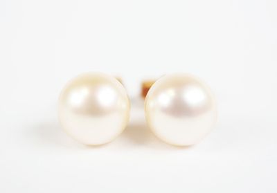 pair of pearl earrings on a white background