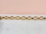 a close up of a gold chain on a white surface