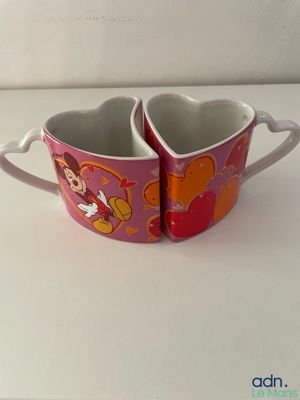mickey and minnie mouse mugs on a white counter top