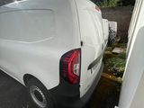 a white van that is parked on the side of the road