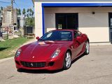the red sports car is parked in front of a building