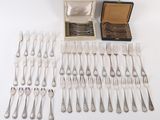 many forks and spoons laid out on the table