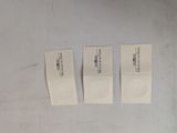 three white business cards sitting next to each other on a table