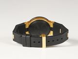 black and gold watch on a white surface