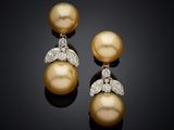a pair of pearl and diamond earrings