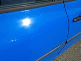 a blue car that is parked on the side of the road