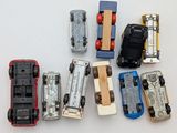 several toy cars are lined up in a row on a white surface
