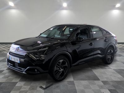 the black suv is parked in a large room with a checkered floor