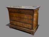 a wooden dresser with a marble top on top of it