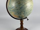 an old globe on a wooden stand with a white background