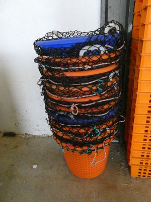 many orange baskets stacked on top of each other next to each other
