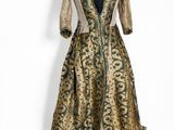 a gold and black dress with a gold and green pattern
