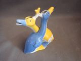 a blue and yellow bird figurine sitting on a gray surface