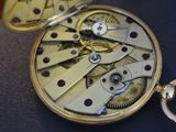 a close up of a pocket watch with a keychain