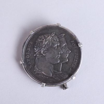a silver coin with a picture of a woman on it