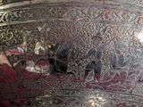a large silver vase with intricate designs on it