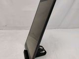 a tablet computer sitting on a stand on a white surface