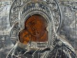 a close up of a silver plate with an image of a woman holding a child