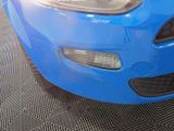a close up of a car ' s front bumper and headlight