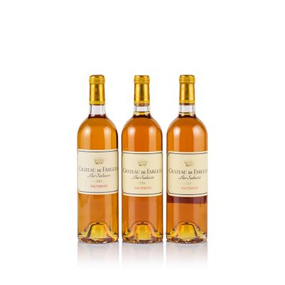 three bottles of wine sitting next to each other on a white surface