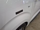 a close up of a white van with a sticker on it