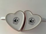 two heart shaped tins that are sitting on a table