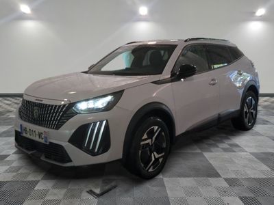 a white suv is parked on a checkered floor in a showroom