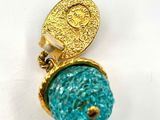 an image of a pair of gold and turquoise earrings with a coin