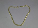 a gold chain on a white background