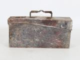a metal box with a handle on a white surface