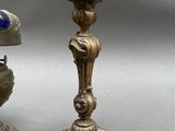 pair of antique brass candlesticks with blue and white glass