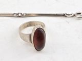 sterling silver ring with a red stone on a chain