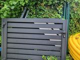 a yellow hose sitting next to a fence and a yellow hose