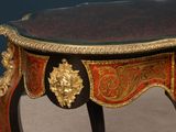 a small table with a red and gold decoration on it