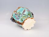 a small blue and white vase with a bird on it