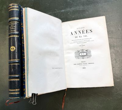 an open book sitting on top of a table next to a pair of scissors