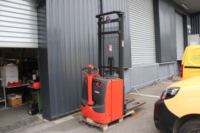 a fork lift truck parked in front of a building