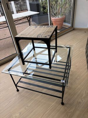 une table en verre surmontée d'un piètement en métal
